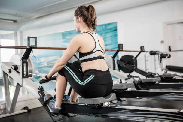a female trainer exercising on a rowing machine