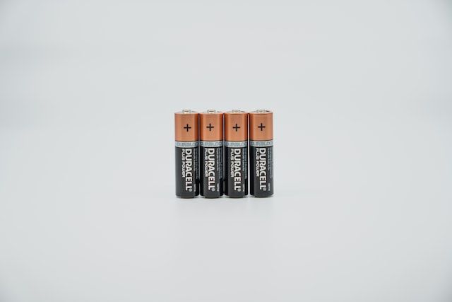 four batteries in a grey background